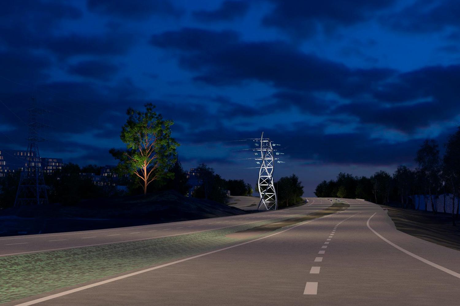 Valaistu Viäntö-niminen maisemapylväs ja vanha mänty loistaa yössä moottoritien varrella.